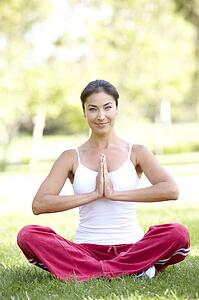 Young Woman Doing Yoga In Park