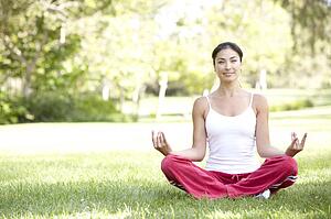 Young Woman Doing Yoga In Park