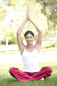 Young Woman Doing Yoga In Park