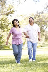 Senior Couple Running In Park
