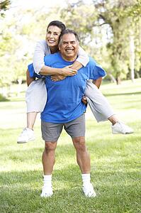 Senior Couple In Sports Clothing Having Fun In Park