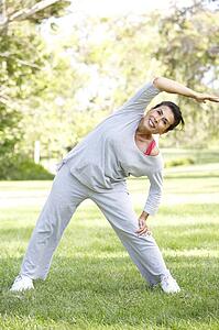 Senior Woman Exercising In Park