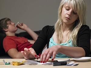 Teenage Couple Taking Drugs At Home
