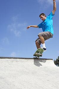 Teenage Boy In Skateboard Park