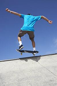 Teenage Boy In Skateboard Park