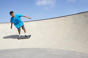 Teenage Boy In Skateboard Park