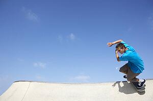 Teenage Boy In Skateboard Park