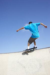 Teenage Boy In Skateboard Park