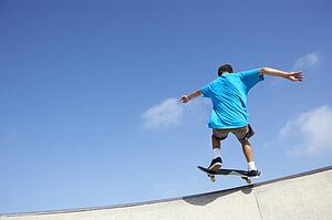 Teenage Boy In Skateboard Park