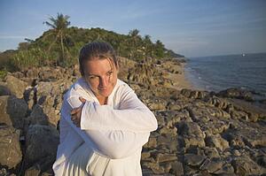 Woman on rocky shoreline