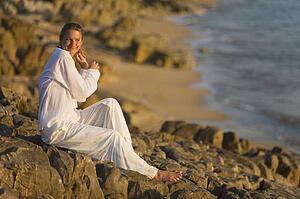Woman on rocky shoreline