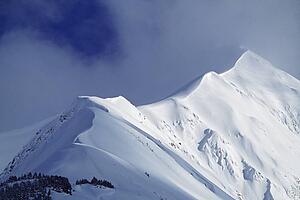 Snow cornice leading up to mountain peak