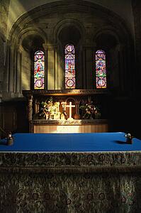 Cross illuminated at the altar of a church