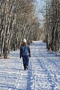 Woman walking on pathway in the winter
