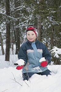 Boy holding a snowball