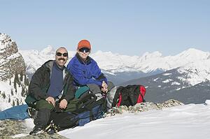 Couple sitting on the top of a mountain