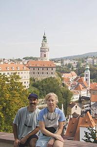 Couple sitting with Krumlov Chateau and Round Tower in background