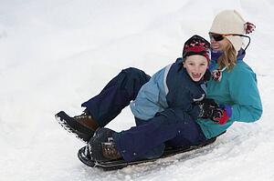 Mother and son sledding