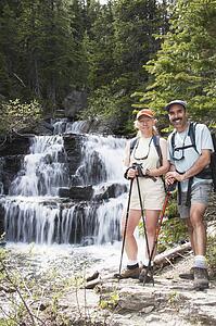 Couple hiking near a waterfall