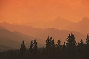 Silhouette of mountain ranges and orange sky