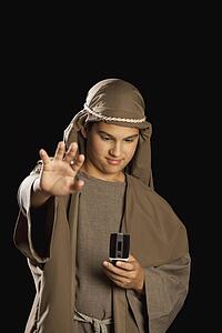 boy depicting jesus holding a cellphone
