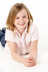 Young Girl Lying On Stomach In Studio