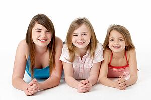 Three Girls Piled Up In Pyramid In Studio