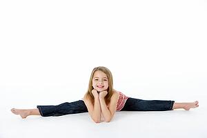 Young Girl In Gymnastic Pose Doing Splits