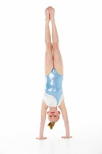 Studio Portrait Of Young Female Gymnast Doing Handstand