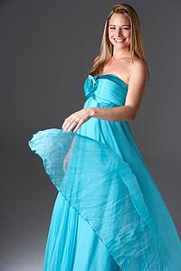 Full Length Studio Shot Of Young Woman In Blue Evening Dress