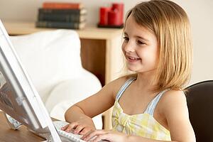 Young Girl Using Computer At Home
