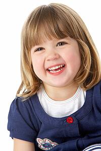Studio Portrait Of Laughing Young Girl