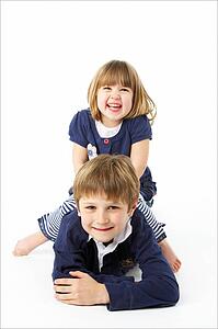 Studio Portrait Of Happy Brother And Sister