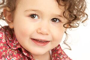 Close Up Studio Portrait Of Smiling Young Girl