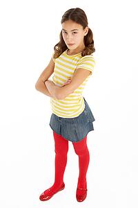 Studio Portrait Of Defiant Young Girl