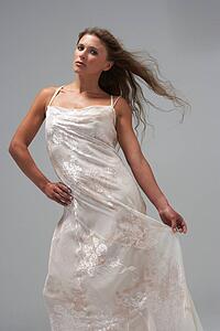 Full Length Studio Shot Of Young Woman In White Evening Dress
