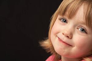 Close Up Studio Portrait Of Smiling Young Girl