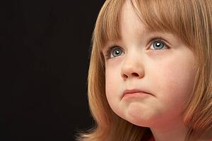 Close Up Studio Portrait Of Sad Young Girl