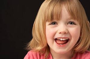 Close Up Studio Portrait Of Smiling Young Girl