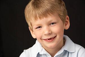Studio Portrait Of Smiling Boy