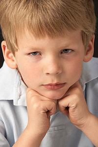 Studio Portrait Of Thoughtful Young Boy