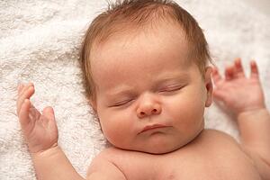 Close Up Of Baby Sleeping On Towel