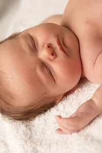 Close Up Of Baby Sleeping On Towel