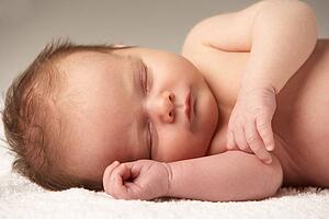 Close Up Of Baby Sleeping On Towel