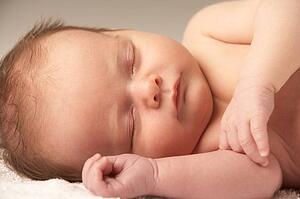 Close Up Of Baby Sleeping On Towel