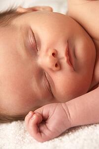Close Up Of Baby Sleeping On Towel