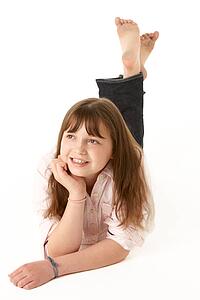 Young Girl Lying On Stomach In Studio