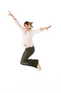 Studio Shot Of Young Girl Jumping In Studio