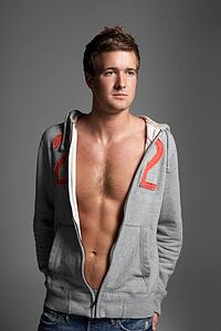 Studio Portrait Of Sexy Young Man Wearing Hooded Sweat Top