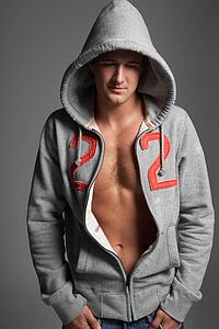 Studio Portrait Of Sexy Young Man Wearing Hooded Sweat Top